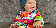 Dora is registered to the contest to win money with this photo: architecture, baby, babylaughing, building, clothing, couch, cushion, dress, face, furniture, happy, head, homedecor, indoors, laughing, person, photography, portrait, sitting, smile