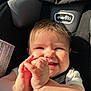 Dora is registered to the contest to win money with this photo: baby, bodypart, car, car_interior, cushion, face, finger, hand, happy, head, homedecor, laughing, newborn, person, photography, portrait, smile, text, transportation, vehicle