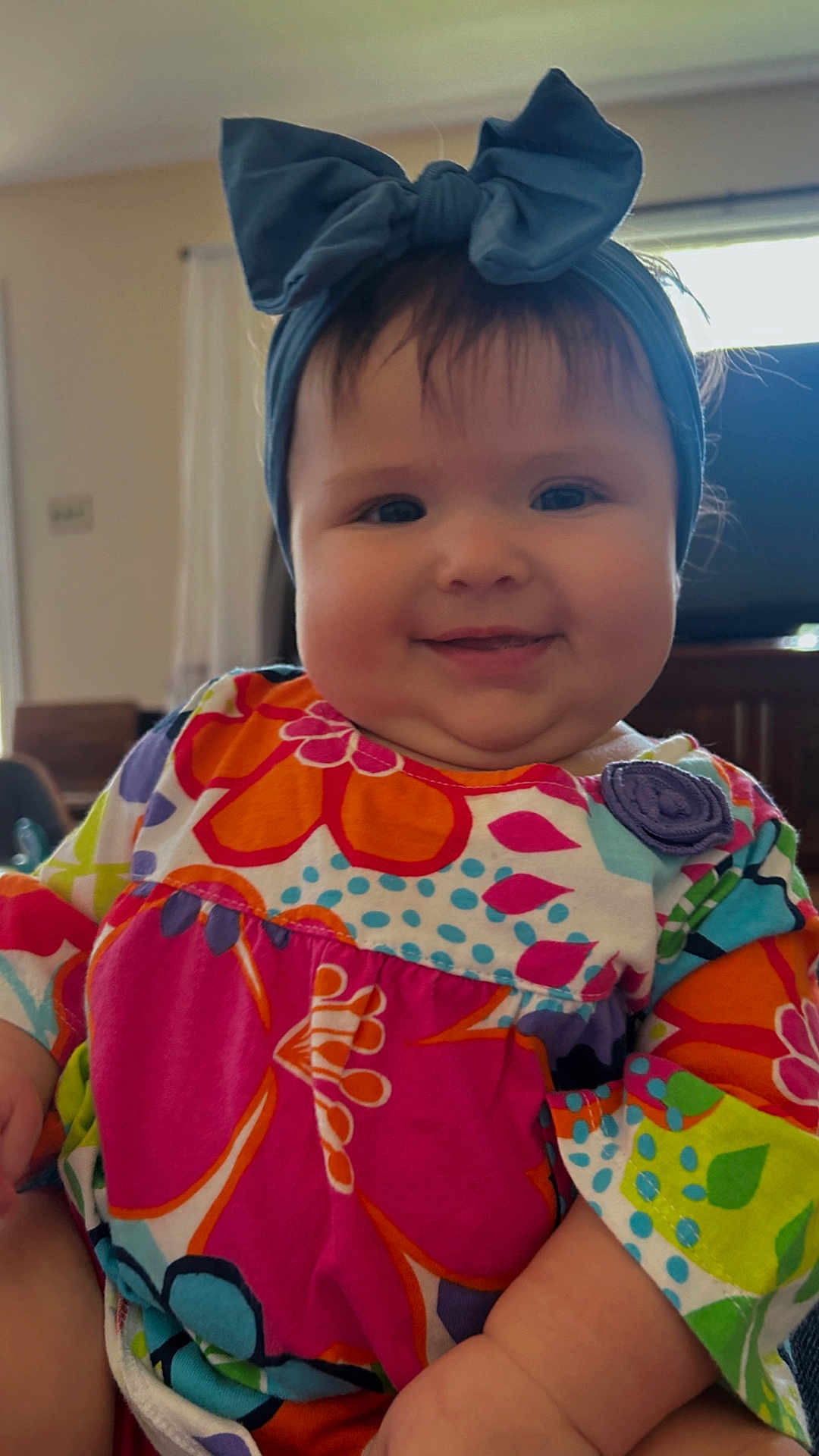 Dora is registered to the contest to win money with this photo: accessories, baby, bonnet, cap, clothing, costume, couch, dress, face, formalwear, furniture, happy, hat, head, headband, homedecor, person, photography, portrait, t_shirt