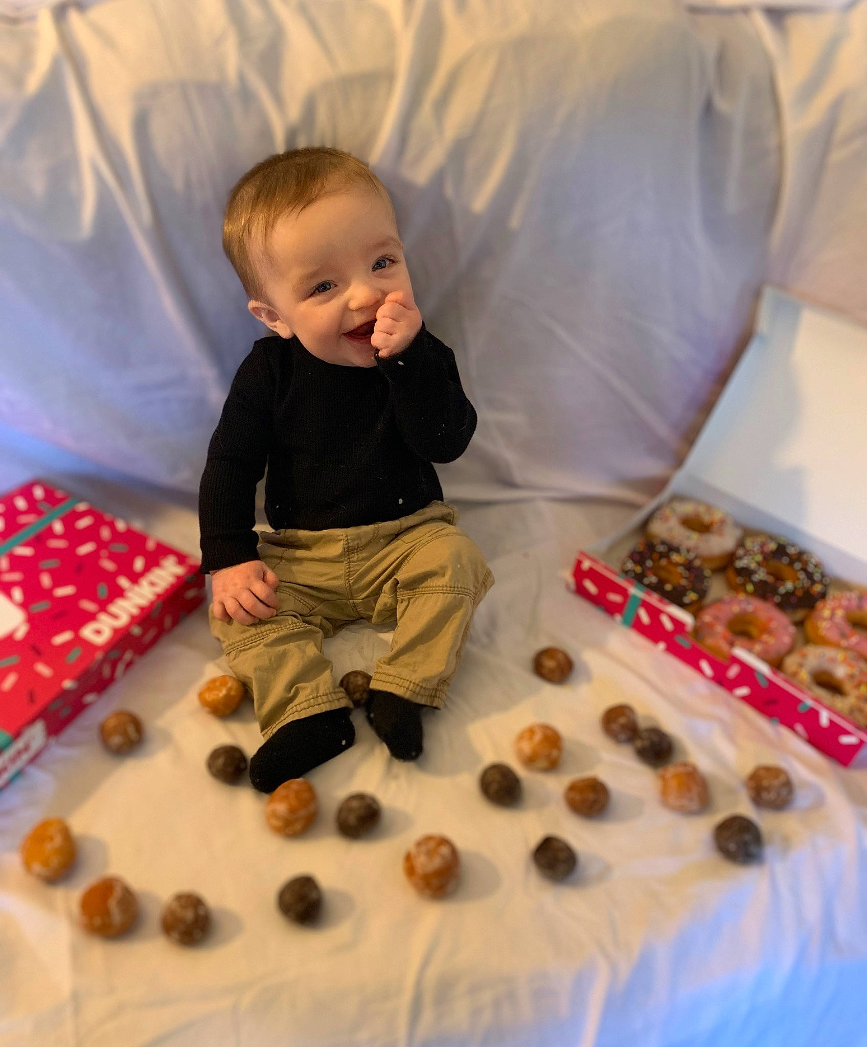 Braylon is registered to the contest to win money with this photo: baby, baby_toddler_clothing, child, comfort, event, flooring, food, fun, linens, orange, pattern, person, play, room, sitting, sleeve, smile, sweetness, textile, toddler