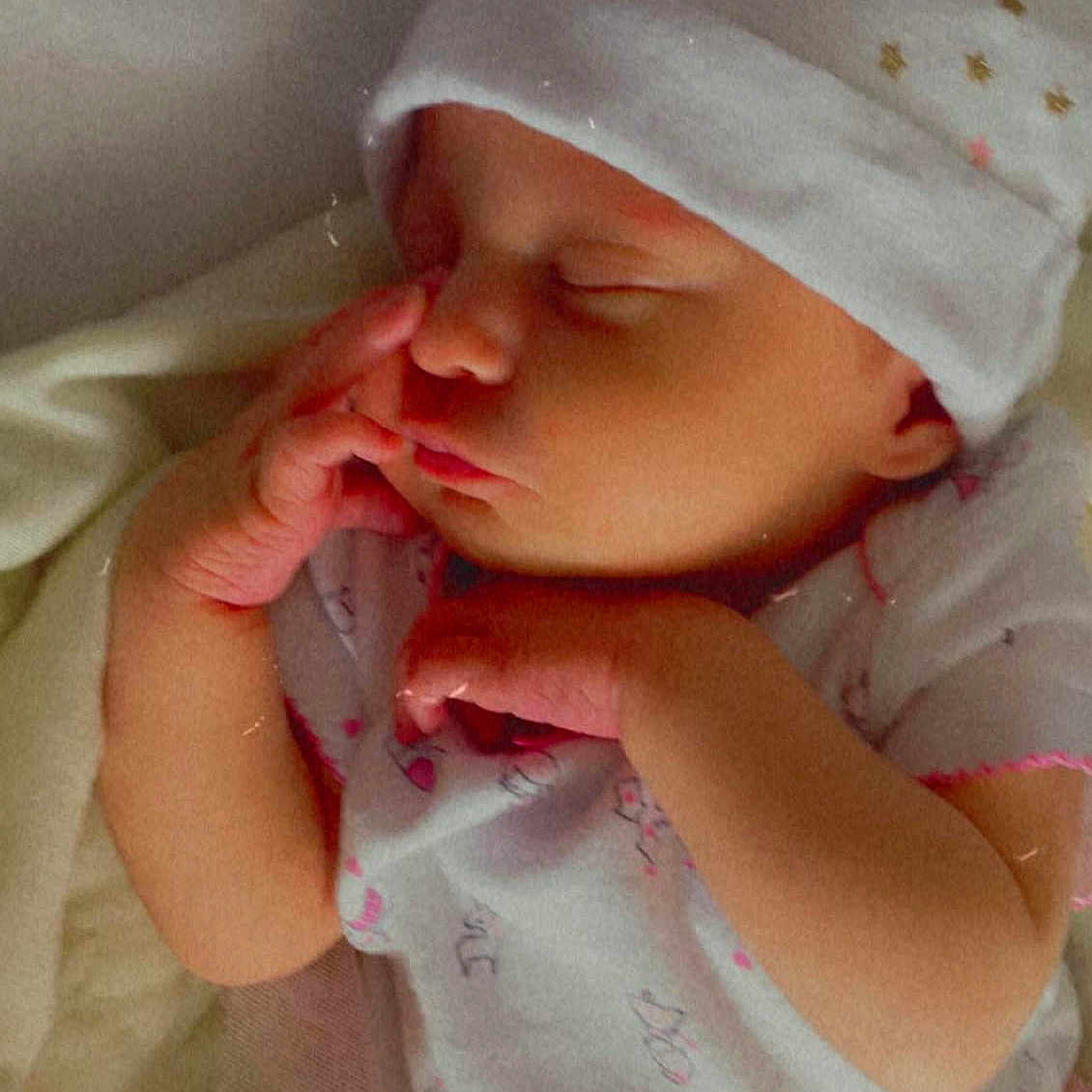 Olivia Grace joined the competition — help win amazing prizes! baby, baby_sleeping, baby_toddler_clothing, cap, cheek, chin, comfort, eye, finger, gesture, hand, headgear, lip, mouth, nose, pink, skin, sleeve, textile, toddler