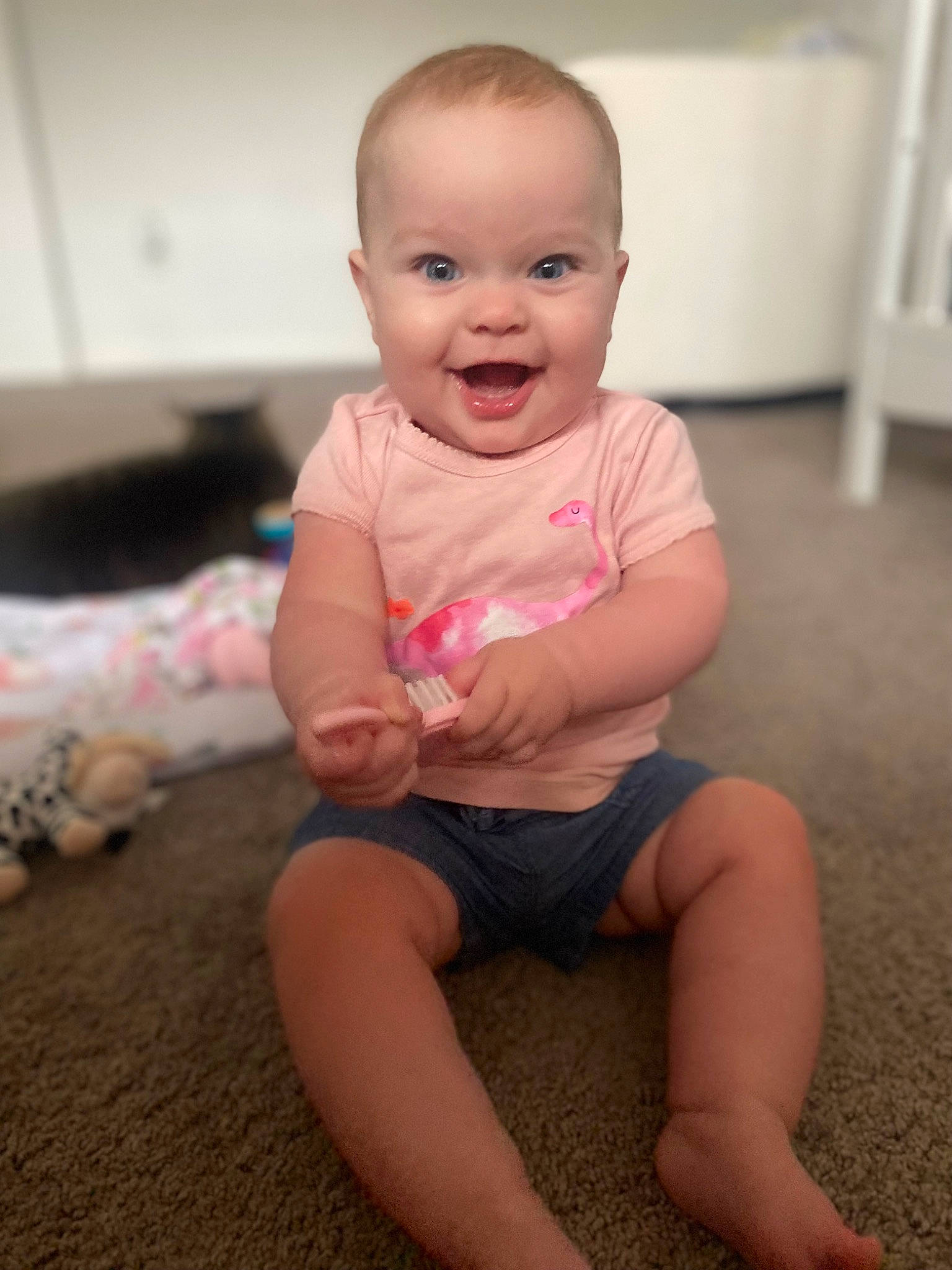 Braelynn is registered to the contest to win money with this photo: baby, baby_toddler_clothing, cheek, child, chin, clothing, finger, floor, flooring, happy, human_body, joint, joy, knee, lip, person, pink, skin, sleeve, smile