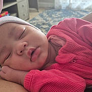 Odessa joined the competition — help win amazing prizes! baby, sleeping, hat, bunny_ears, pink_clothing, infant, closeup, cute, resting, hand, tattoo, person, indoor, soft_light, face, child, cozy, portrait, peaceful, newborn