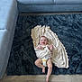 baby, blanket, child, comfort, couch, cozy, cute, diaper, floor, furniture, happy, home, indoors, infant, living_room, person, plush, rug, smiling, wooden_floor