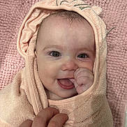 Mila joined the competition — help win amazing prizes! baby, blanket, child, closeup, cute, expression, face, hand, happy, indoors, infant, peach, person, pink, portrait, skin, smiling, towel, warm, wrapped