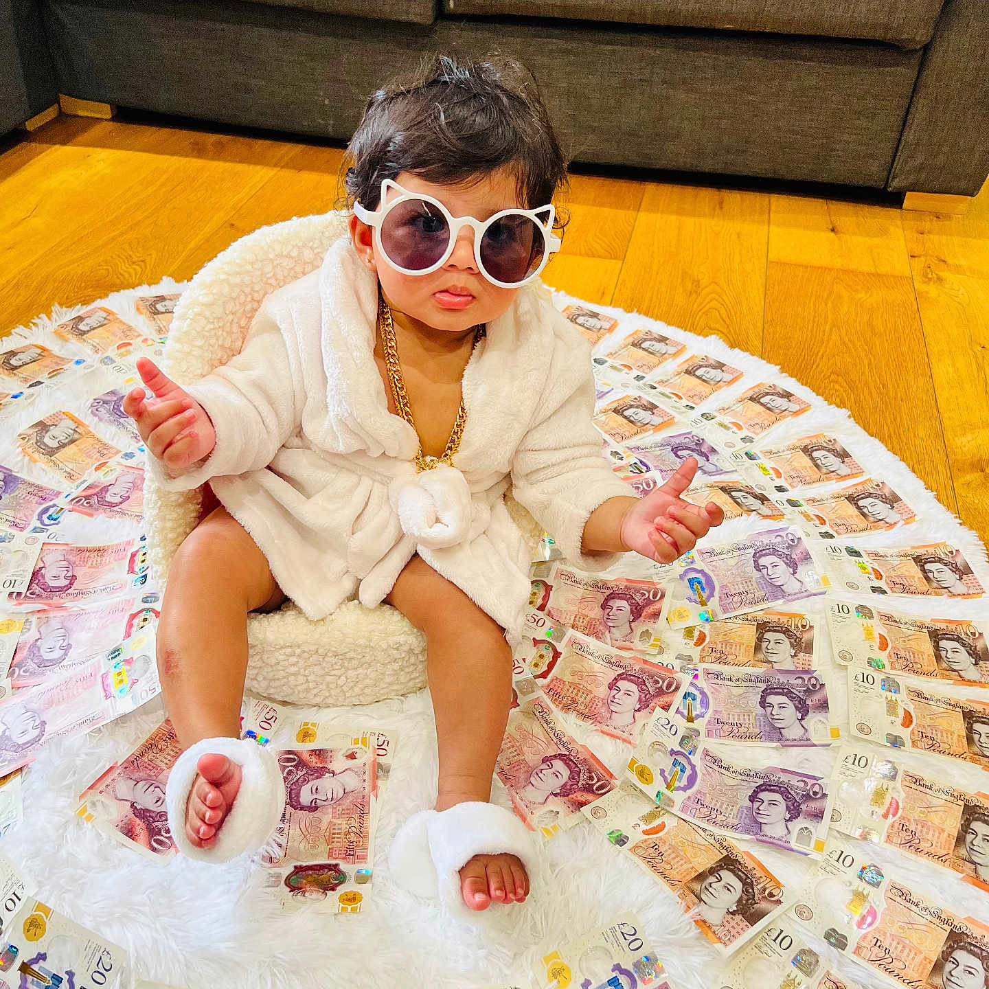 Trisha joined the competition — help win amazing prizes! accessory, baby, british_pounds, chair, child, currency, cute, expression, fashion, floor, footwear, indoor, luxury, money, plush, portrait, robe, sitting, sunglasses, wooden_floor