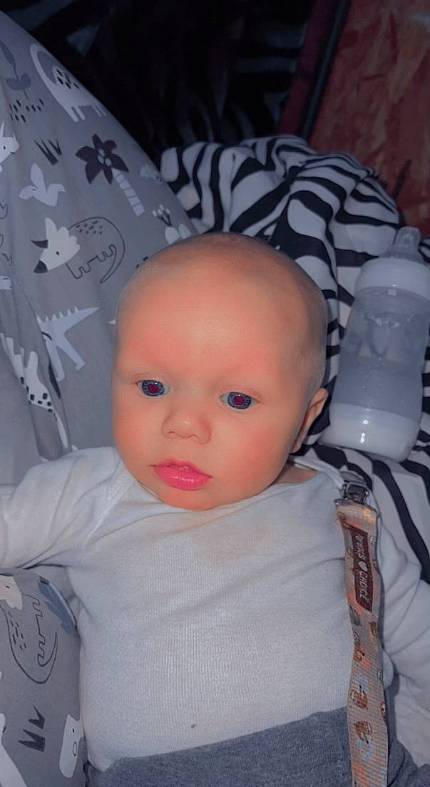 Jake is registered to the contest to win money with this photo: baby, baby_products, baby_toddler_clothing, cheek, child, cool, doll, eye, eyebrow, eyelash, fashion_accessory, flash_photography, fur, headgear, iris, pattern, person, t_shirt, textile, toddler