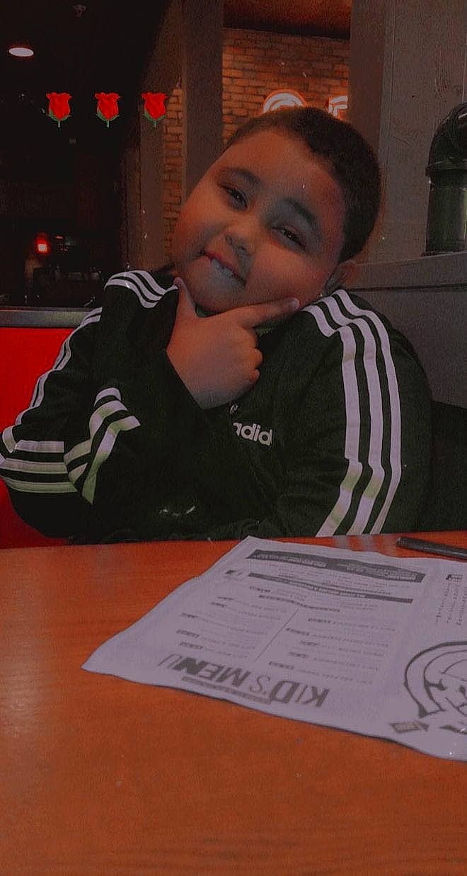 Jaydin is registered to the contest to win money with this photo: carmine, chair, child, event, flooring, font, fun, handwriting, jacket, job, person, room, sitting, smile, t_shirt, table, toddler, writing