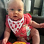 Brynley is registered to the contest to win money with this photo: baby, infant, child, blue_eyes, bib, watermelon_pattern, coral_clothing, mermaid_cartoon, soft_toy, mirror, couch, leather, indoor, home, curious, sitting, cute, chubby_cheeks, person, portrait