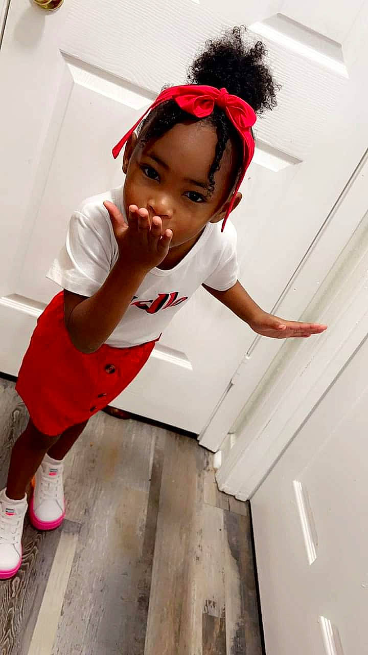 Macy Rogers joined the competition — help win amazing prizes! baby_toddler_clothing, carmine, child, child_model, elbow, fashion_accessory, fashion_design, flooring, fun, happy, headband, human_leg, knee, person, room, shorts, sleeve, sock, t_shirt, thigh