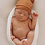 newborn, baby, sleeping, hat, brown_hat, bear_ears, blanket, wrapped, skin, feet, hand, infant, cute, soft_texture, cozy, portrait, indoors, rest, peaceful, child