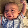 Kaine is registered to the contest to win money with this photo: baby, smiling, infant, blue_onesie, striped_clothing, raising_arm, happy, face, cheeks, tongue, lying_down, fabric, bed, cute, skin, child, person, newborn, closeup, indoor
