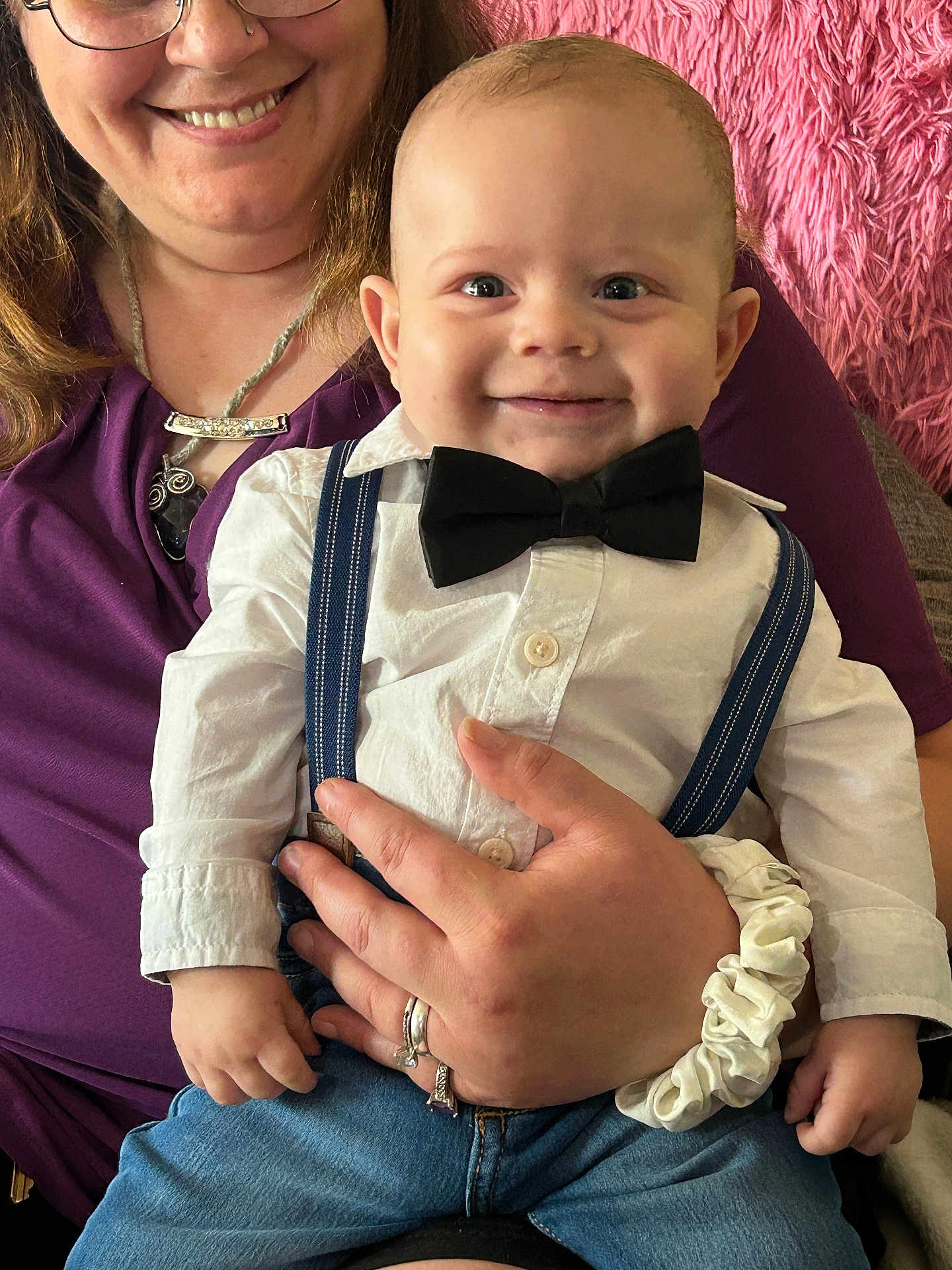 Kaine joined the competition — help win amazing prizes! baby, child, smiling, bow_tie, white_shirt, suspenders, blue_jeans, woman, purple_top, hand, ring, scrunchie, glasses, nose_ring, indoor, portrait, happy, cute, holding, furniture