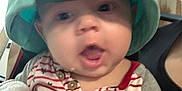 Kaine is registered to the contest to win money with this photo: baby, child, hat, cap, clothing, striped_shirt, stars, blanket, indoor, person, face, expression, cute, young, portrait, sitting, casual, headwear, infant, closeup