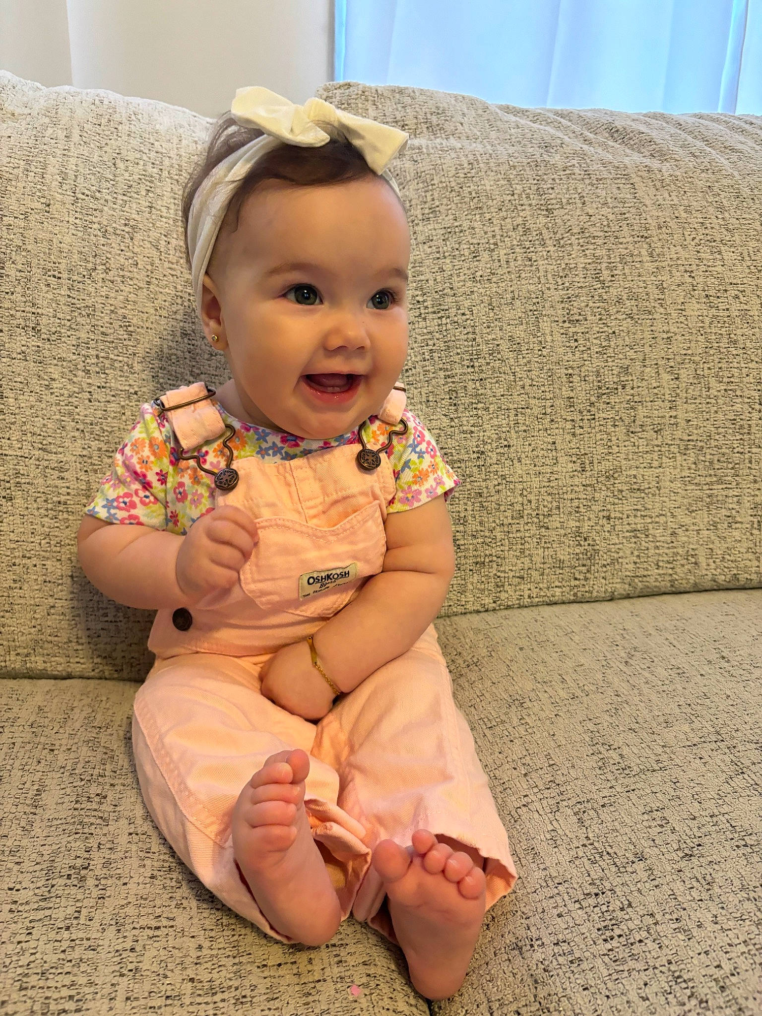 Jolene joined the competition — help win amazing prizes! baby, baby_toddler_clothing, cheek, comfort, couch, dress, eye, floor, flooring, foot, happy, head, human_body, human_leg, iris, person, sitting, skin, sleeve, smile