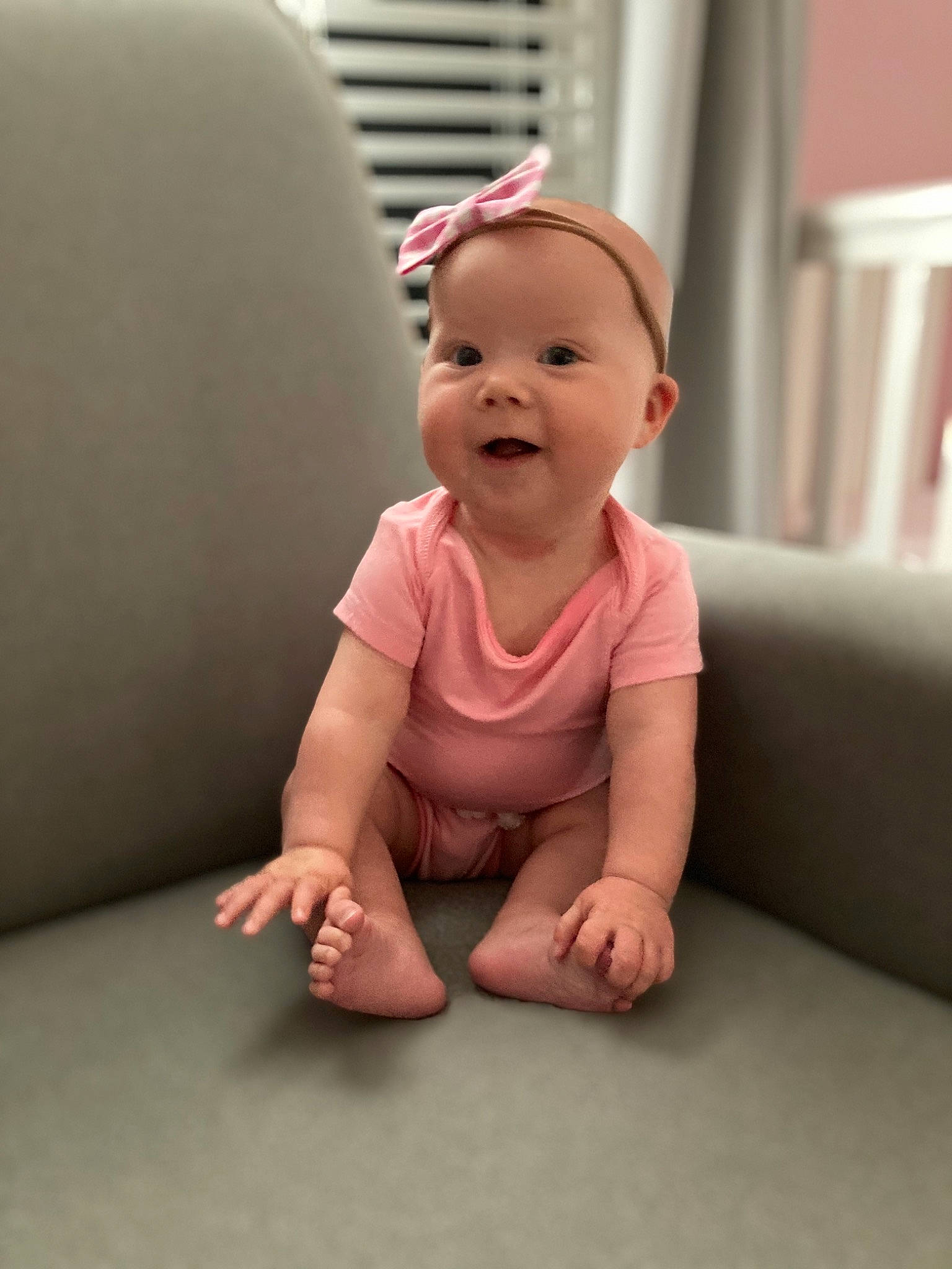 Elsa is registered to the contest to win money with this photo: arm, baby, cheek, child, crawling, face, finger, floor, flooring, hand, head, leg, person, photography, pink, play, sitting, skin, smile, toddler