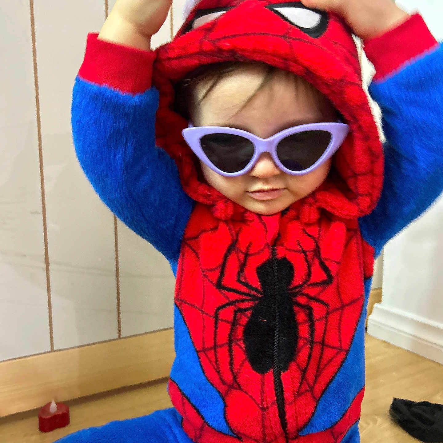 Tallulah is registered to the contest to win money with this photo: accessories, baby, clothing, coat, costume, face, glasses, hat, head, hood, hoodie, jacket, knitwear, person, photography, portrait, purple, sunglasses, sweater, sweatshirt