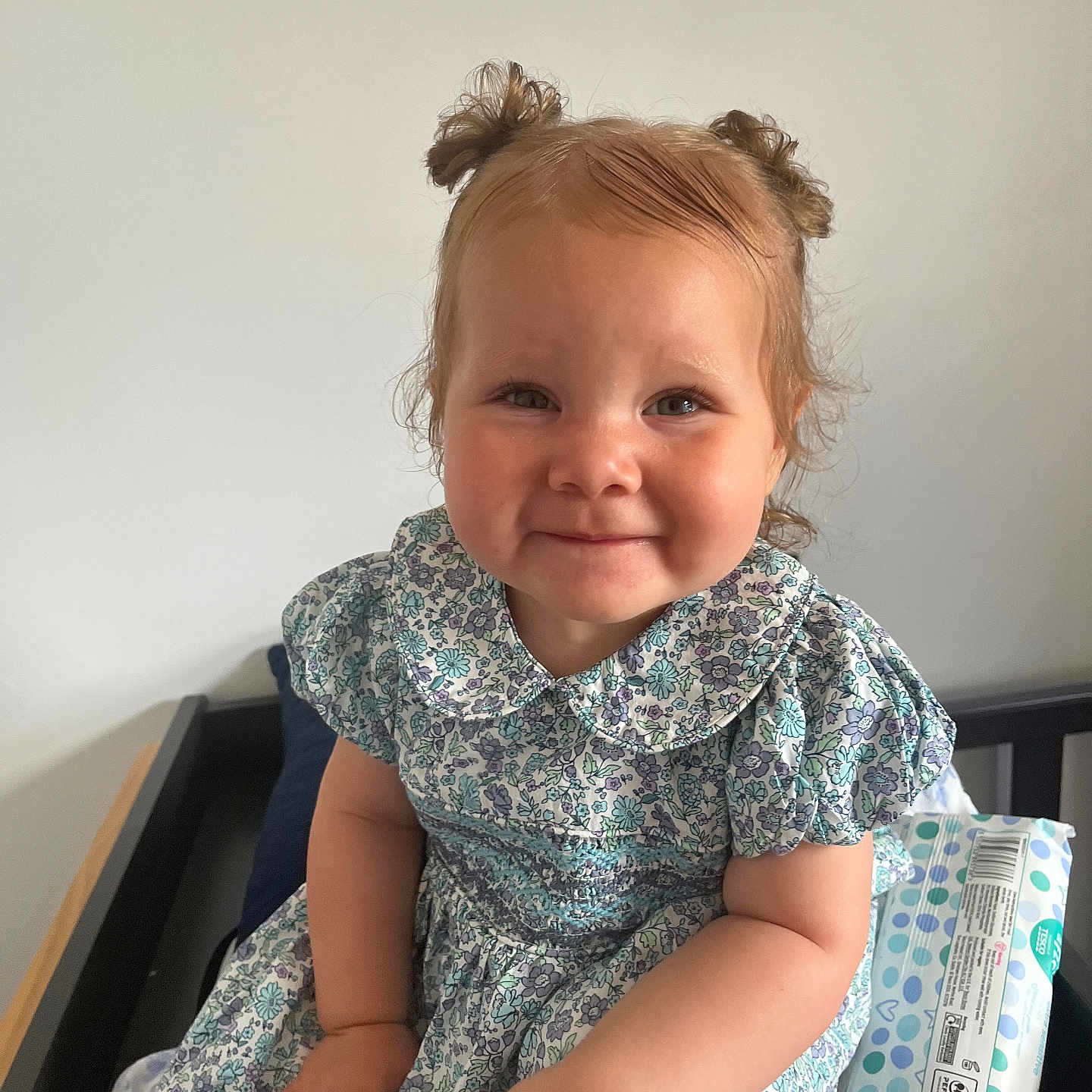 Aamirah is registered to the contest to win money with this photo: baby, baby_clothes, bed, blanket, casual, child, cute, diaper_wipes, dress, face, hair_buns, happy, indoor, infant, person, portrait, sitting, smiling, toddler, young_child