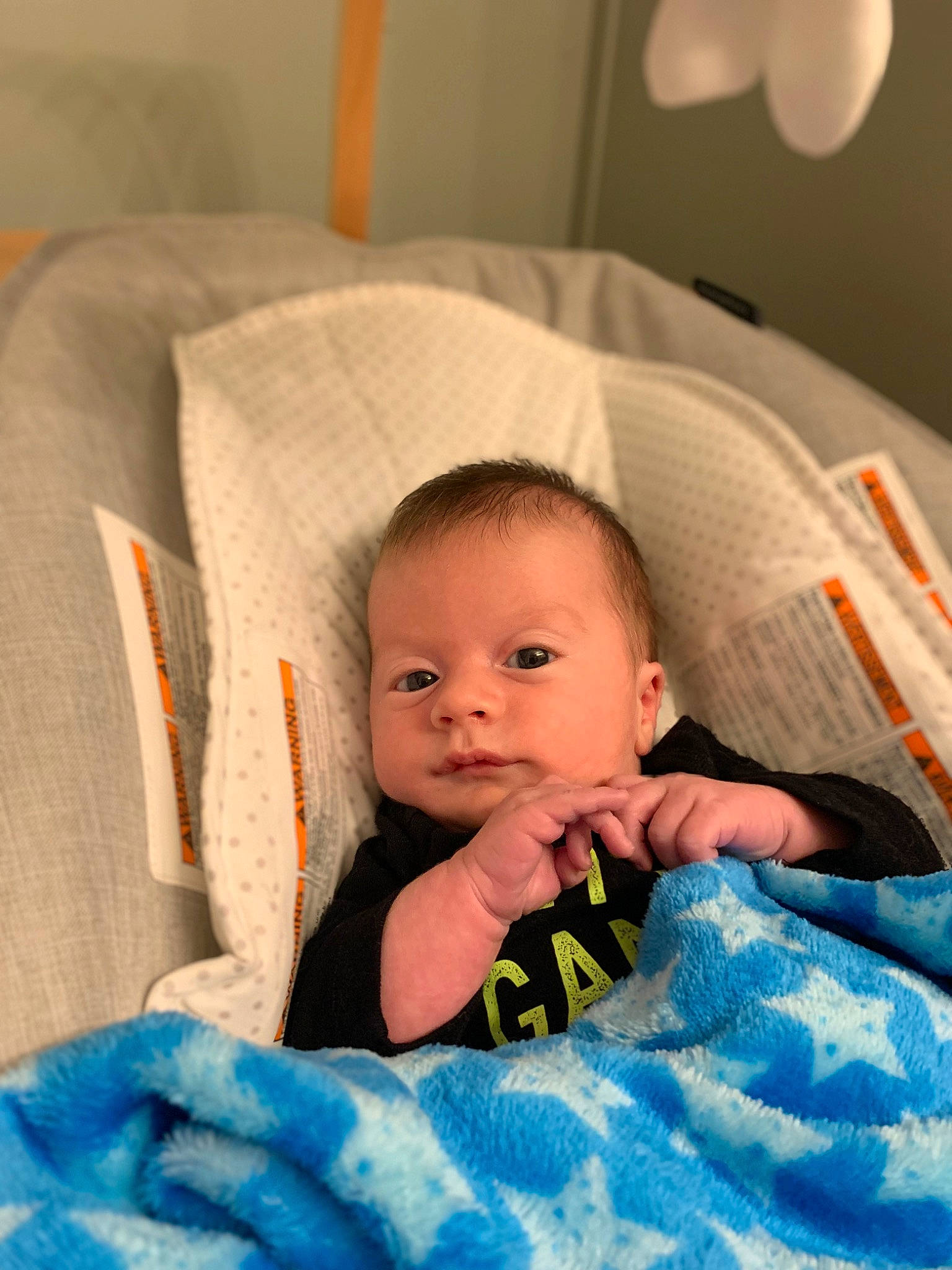 Jaxon is registered to the contest to win money with this photo: baby, baby_products, baby_toddler_clothing, bedding, bedtime, cheek, child, comfort, eye, eyebrow, fun, happy, head, iris, linens, person, room, sitting, smile, textile