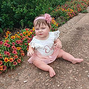 Starla joined the competition — help win amazing prizes! baby, barefoot, child, cute, daylight, flower_bed, flower_headband, gravel_path, greenery, headband, nature, outdoor, pink_tutu, plants, sitting, skin, summer, toddler, white_dress, young_child