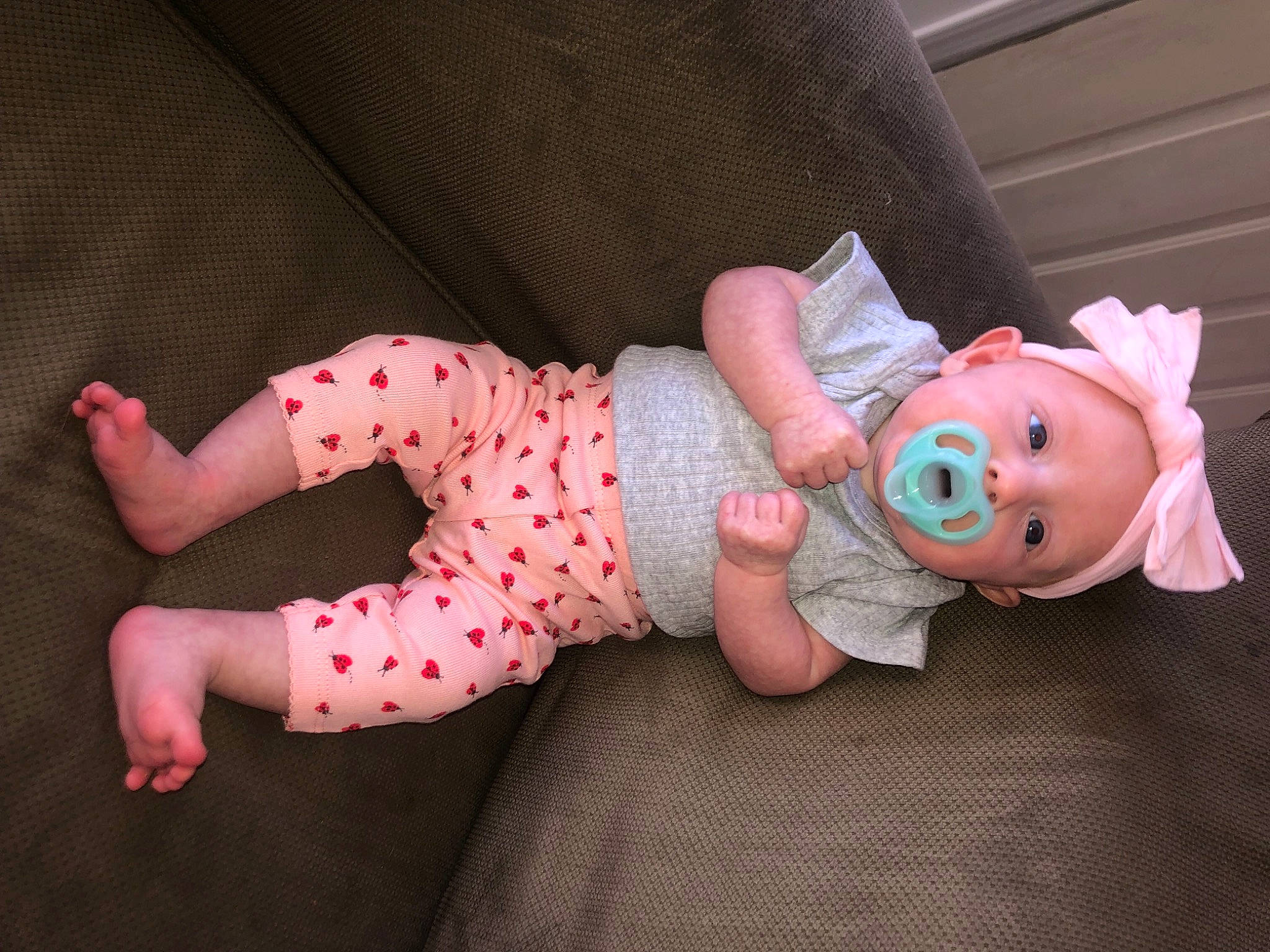 Daisy is registered to the contest to win money with this photo: baby, baby_products, baby_toddler_clothing, child, comfort, foot, fun, hat, human_body, human_leg, leg, linens, pattern, person, pink, sitting, skin, sleeve, sock, thigh