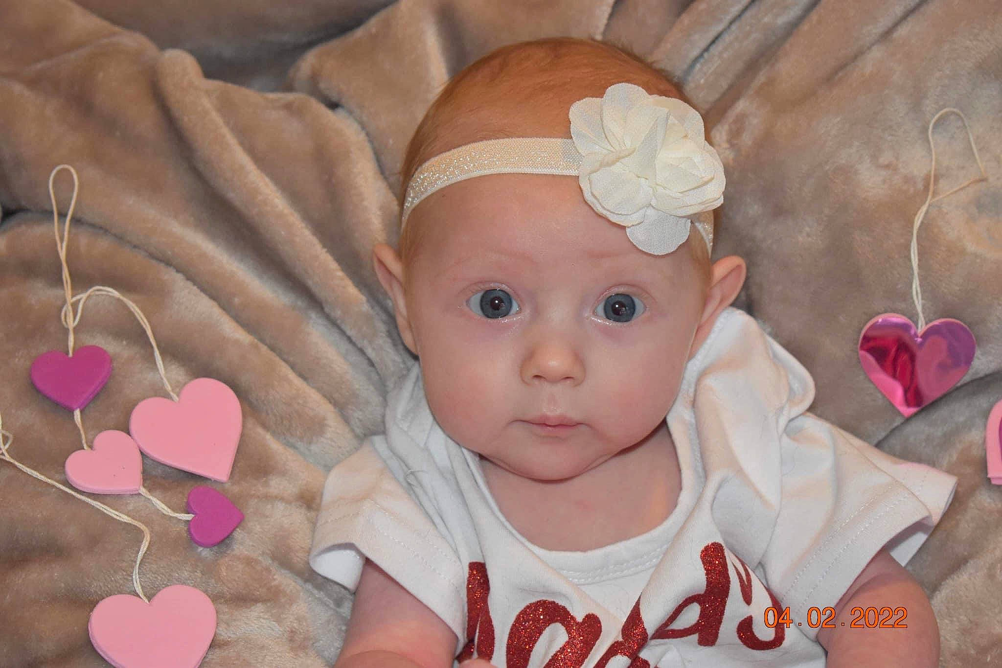 Daisy joined the competition — help win amazing prizes! baby, baby_products, baby_toddler_clothing, cap, cheek, eye, face, facial_expression, finger, happy, headgear, headwear, lip, nose, organ, person, pink, skin, textile, toddler