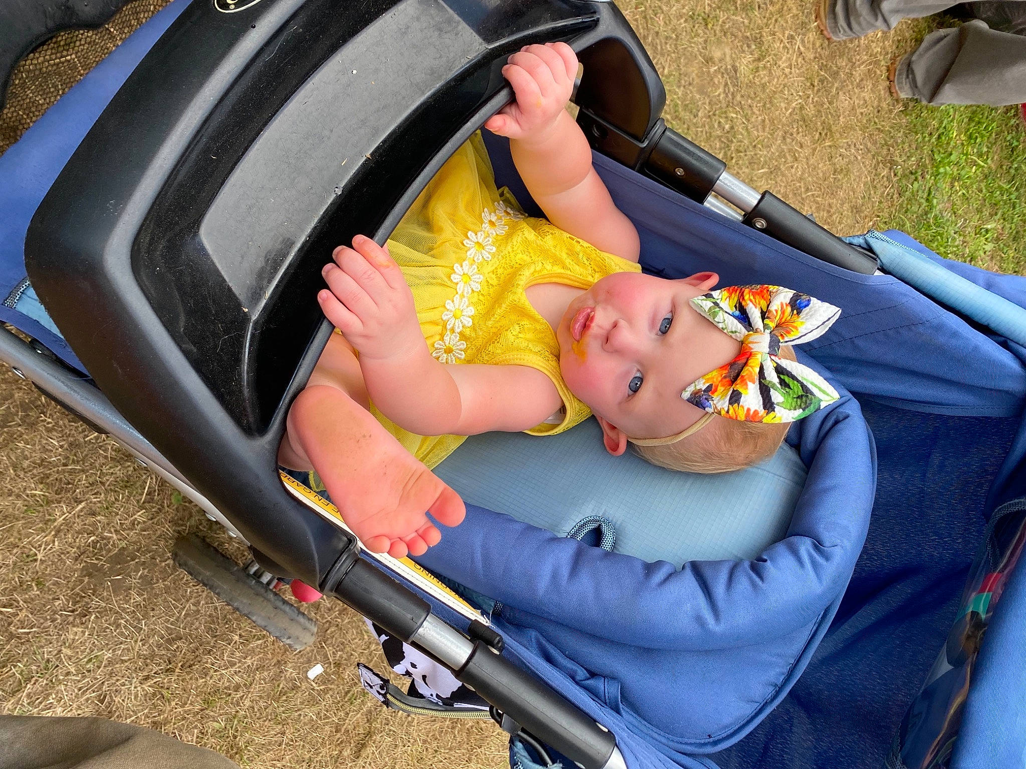 Daisy is registered to the contest to win money with this photo: auto_part, automotive_design, automotive_exterior, automotive_tire, baby, baby_carriage, baby_products, bumper, car_seat, chair, child, comfort, family_car, grass, headwear, lap, leisure, motor_vehicle, person, recreation