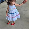 child, girl, white_dress, rainbow_stripes, red_shoes, holding_hands, adult_hand, sidewalk, outdoor, curly_hair, portrait, standing, casual, cute, person, fashion, summer, smile, young, background_blur