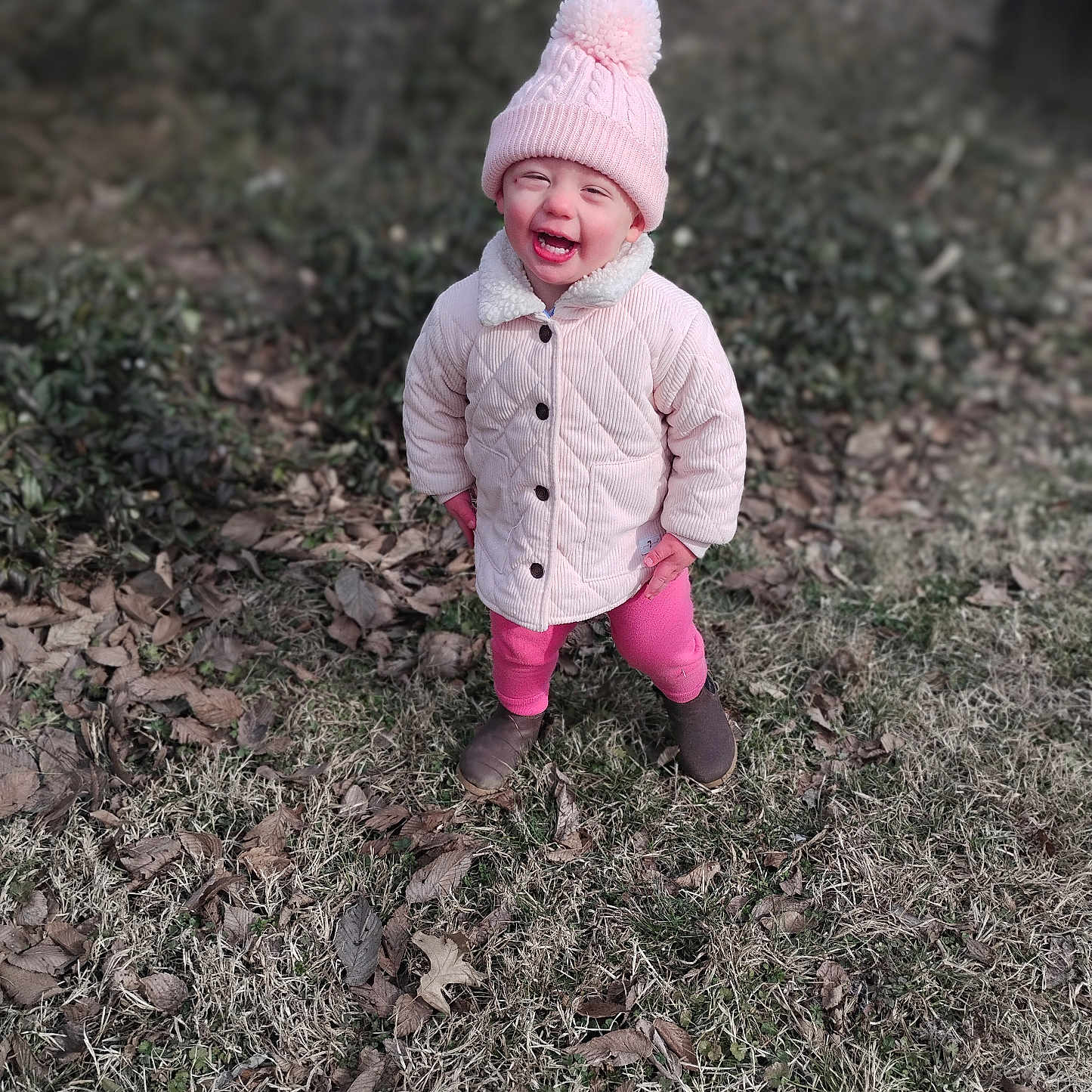 Briley is registered to the contest to win money with this photo: baby, babylaughing, cap, clothing, coat, face, footwear, happy, hat, head, hood, jacket, pants, person, photography, portrait, shoe, sitting, smile, soil