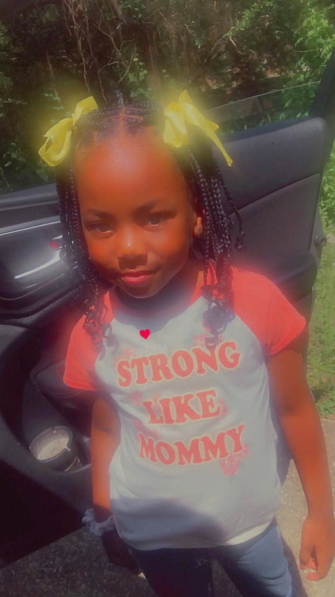 Jakaylyn joined the competition — help win amazing prizes! automotive_exterior, black_hair, car, car_seat, child, cool, eyebrow, facial_expression, family_car, fun, happy, joy, leisure, long_hair, person, skin, t_shirt, tints_and_shades, toddler, trunk