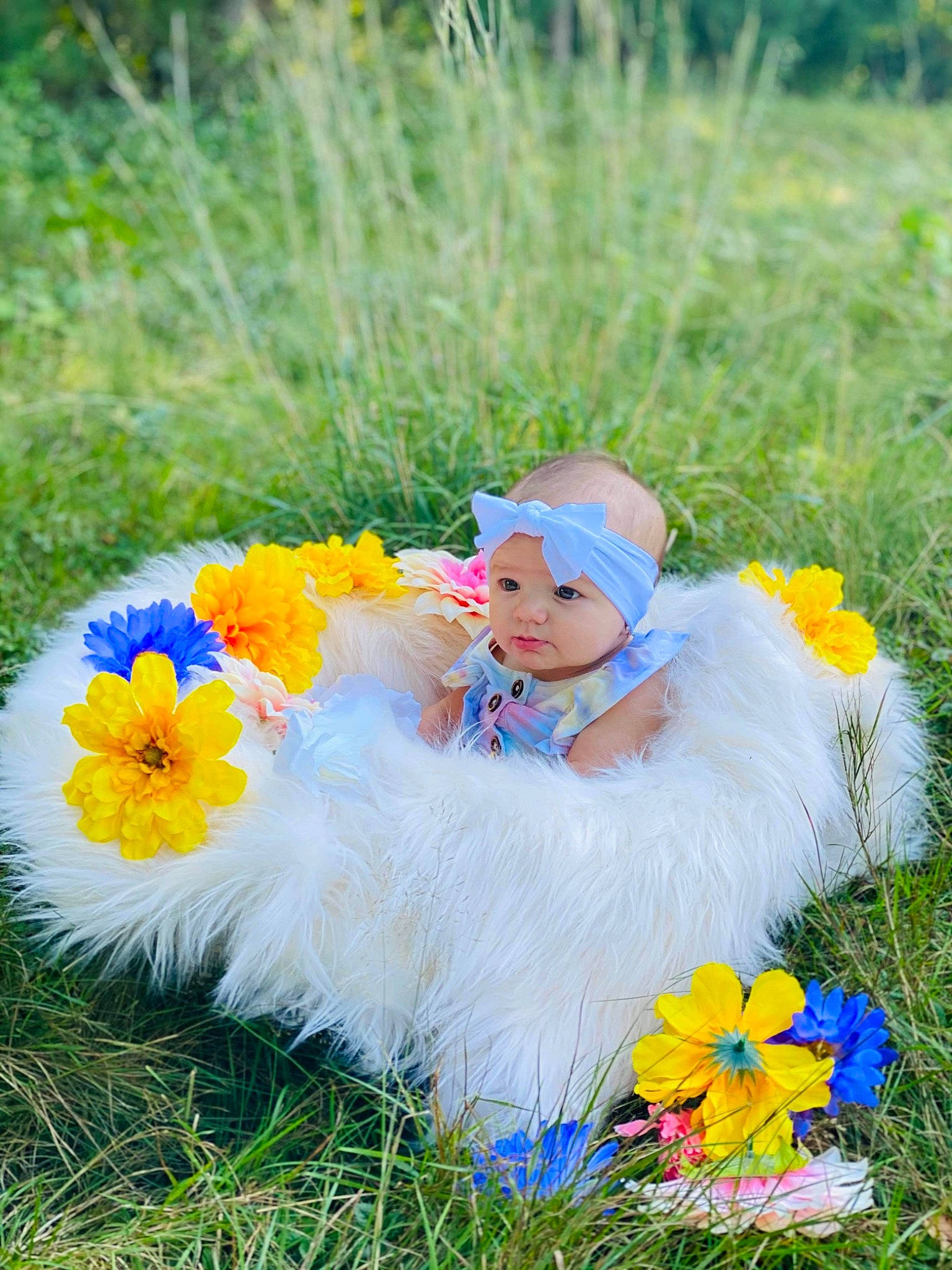 Mahlani is registered to the contest to win money with this photo: baby, baby_toddler_clothing, botany, dress, facial_expression, flower, flowering_plant, grass, grass_family, grassland, happy, headwear, leaf, meadow, natural_environment, nature, people_in_nature, person, petal, plant