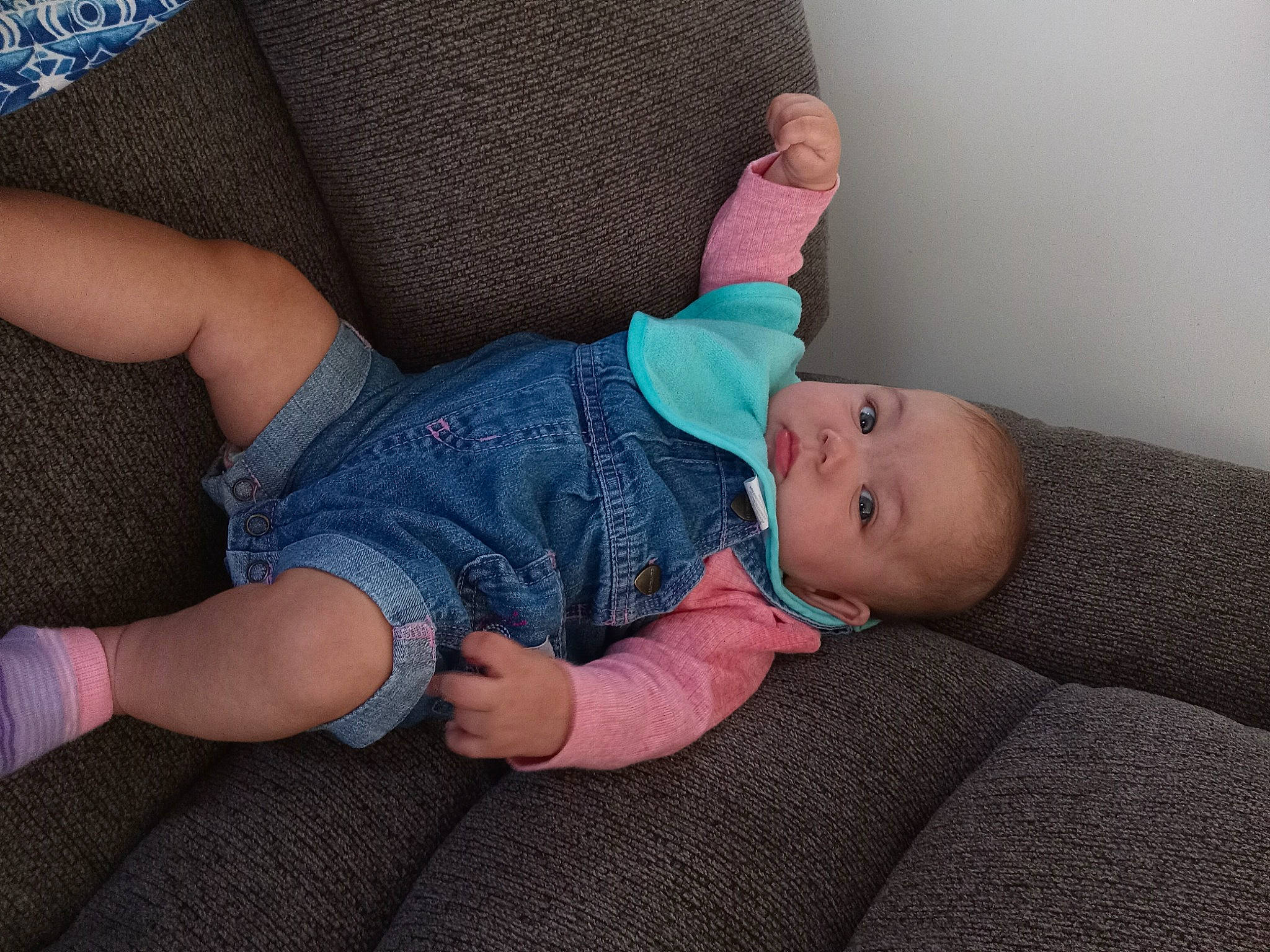 Kiara is registered to the contest to win money with this photo: baby, baby_toddler_clothing, child, comfort, elbow, electric_blue, finger, foot, human_body, human_leg, knee, lap, leg, nail, pattern, person, sitting, sleeve, sock, thigh