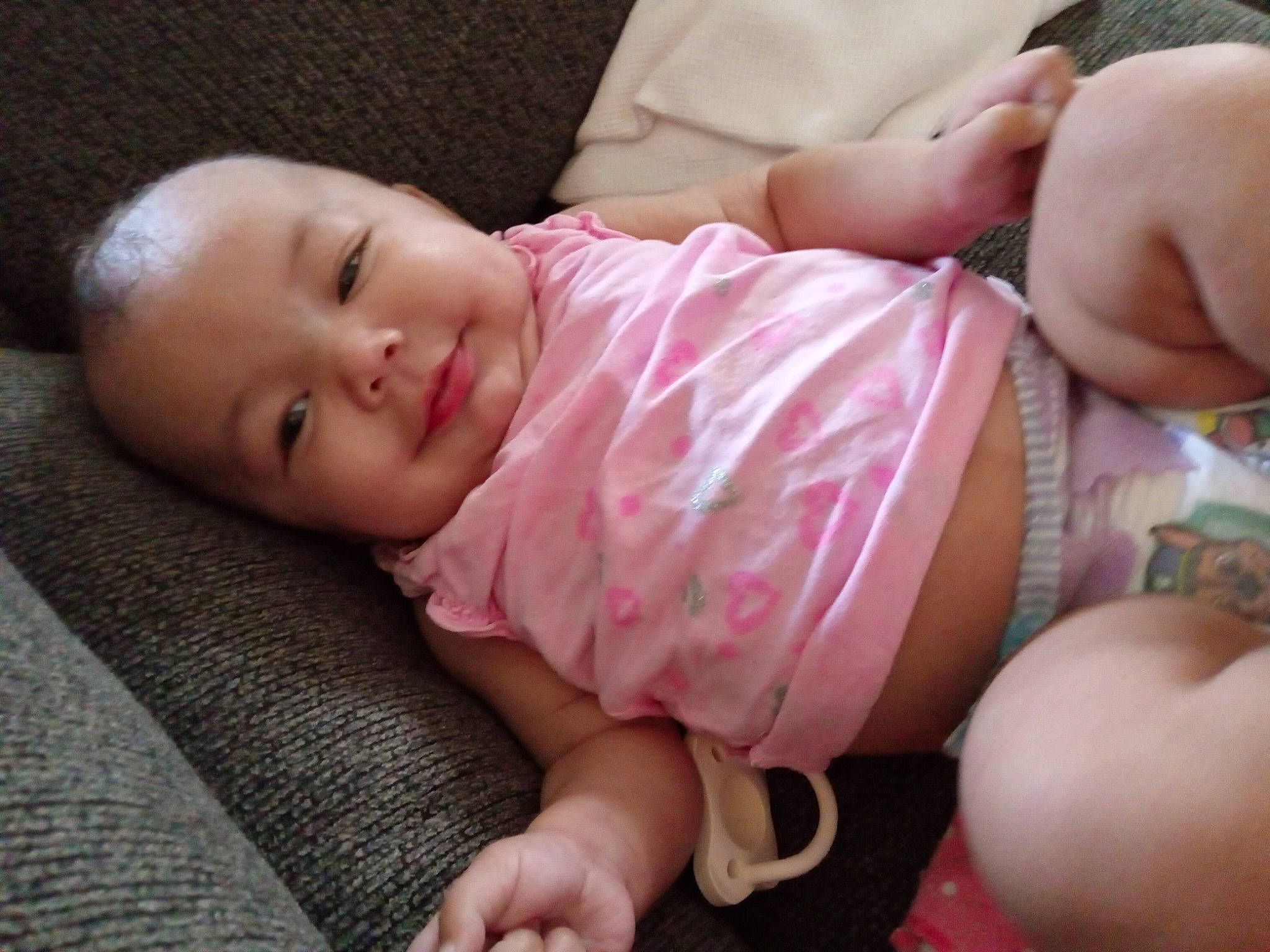 Kiara joined the competition — help win amazing prizes! arm, baby, baby_toddler_clothing, cheek, comfort, eye, finger, human_body, leg, mouth, nail, nose, person, pink, skin, sleeve, smile, textile, thigh, thumb