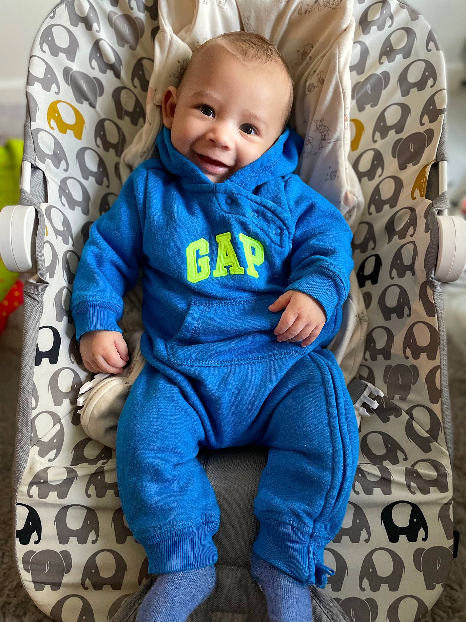 Kamden is registered to the contest to win money with this photo: aqua, azure, baby, baby_toddler_clothing, blue, chair, comfort, electric_blue, eye, grey, happy, joy, linens, outerwear, pattern, person, purple, sitting, sleeve, smile