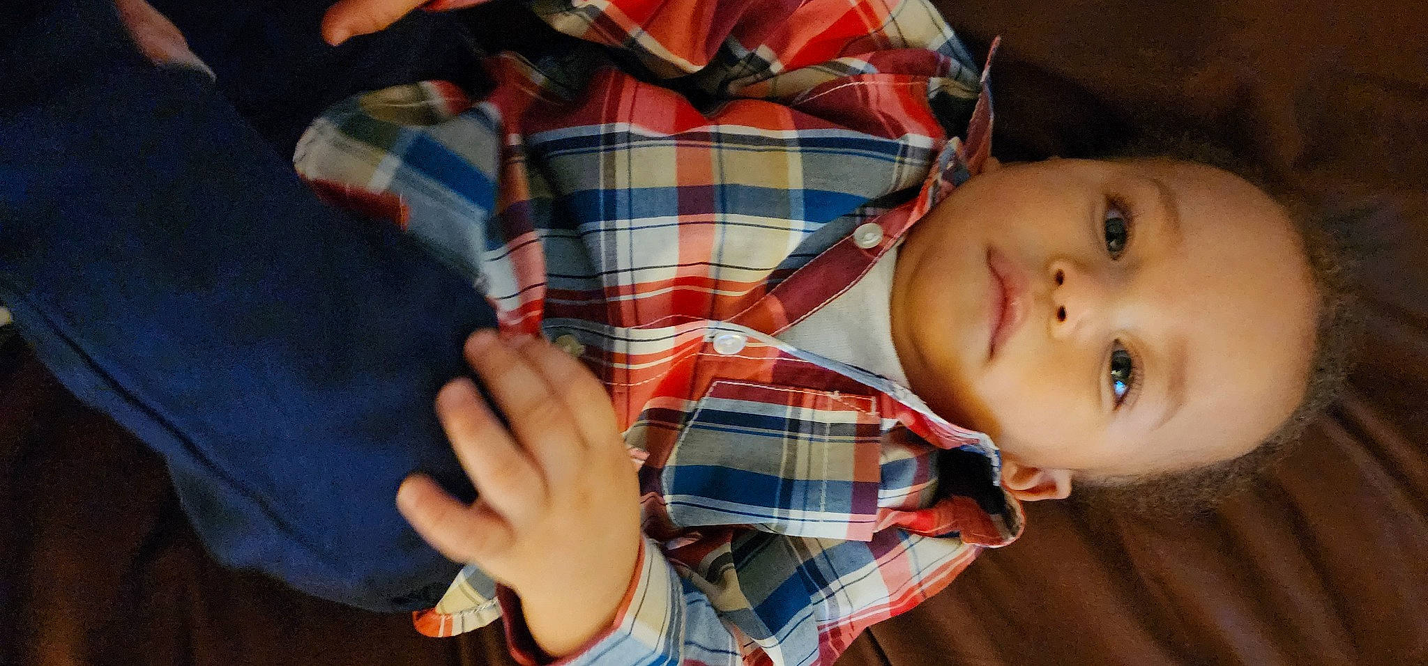 Jay is registered to the contest to win money with this photo: baby, child, comfort, dress_shirt, elbow, finger, gesture, hand, nail, nose, pattern, person, plaid, sitting, skin, sleeve, tartan, thumb, toddler, wood