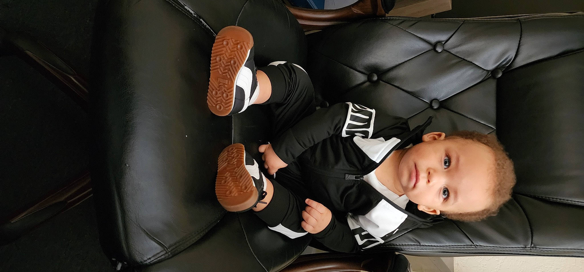 Jay is registered to the contest to win money with this photo: baby_products, chair, comfort, elbow, eyewear, flash_photography, fun, gesture, human_leg, knee, leg, mammal, person, product, room, sitting, suit, thigh, toddler, tree