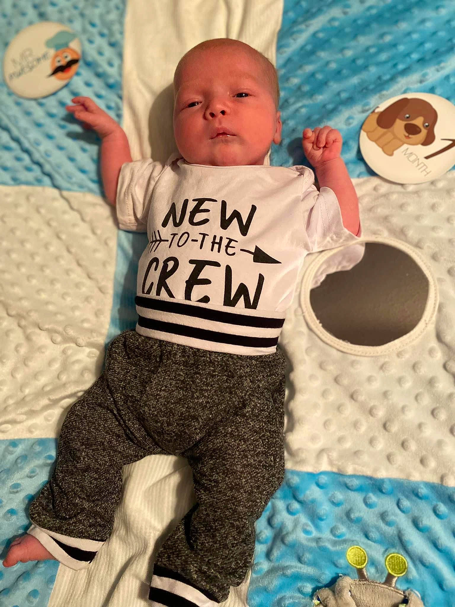 Tanner is registered to the contest to win money with this photo: baby, baby_products, baby_toddler_clothing, blue, child, flooring, fun, happy, jersey, linens, pattern, person, play, sitting, sleeve, sportswear, t_shirt, tableware, textile, thigh