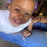 Truee is registered to the contest to win money with this photo: toddler, child, smiling, happy, indoor, person, purple_beads, hair, jeans, ripped_jeans, hand, knee, clothing, face, cute, young_child, joy, human, skin, expression