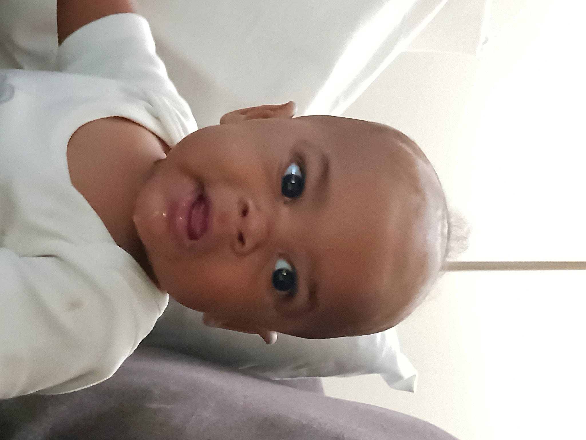 Deandre is registered to the contest to win money with this photo: arm, baby, cheek, chest, child, comfort, elbow, eyebrow, eyelash, lip, mouth, neck, nose, person, shoulder, skin, sleeve, smile, toddler, trunk