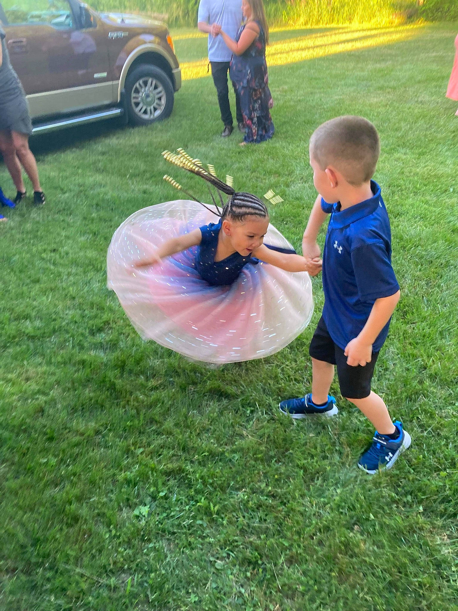 Jayla joined the competition — help win amazing prizes! automotive_tire, car, child, electric_blue, event, fun, grass, grassland, lawn, leisure, outdoor_recreation, person, plant, recreation, shorts, sneakers, t_shirt, tire, toddler, vehicle_door