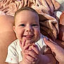 Maïa participe au concours pour gagner de l'argent avec cette photo : baby, infant, smile, clapping, hands, face, eyes, person, skin, blanket, soft_texture, white_clothing, cheeks, happy, cute, closeup, indoor, human, baby_girl, joy