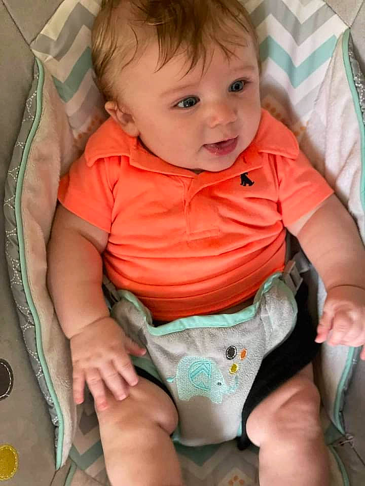 Aden is registered to the contest to win money with this photo: arm, baby, baby_toddler_clothing, cheek, child, comfort, face, finger, head, human_body, iris, mouth, nose, organ, person, pink, skin, sleeve, stomach, thigh