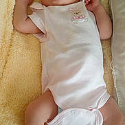 Emma Amaya is registered to the contest to win money with this photo: baby, newborn, sleeping, onesie, hat, pink_socks, blanket, soft_texture, infant, cute, peaceful, resting, child, portrait, indoors, small_arms, small_legs, skin, clothing, cozy