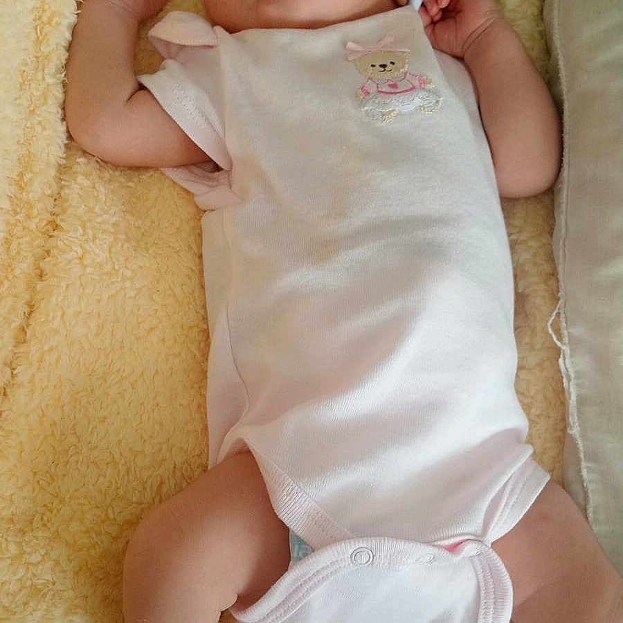 Emma Amaya is registered to the contest to win money with this photo: baby, newborn, sleeping, onesie, hat, pink_socks, blanket, soft_texture, infant, cute, peaceful, resting, child, portrait, indoors, small_arms, small_legs, skin, clothing, cozy