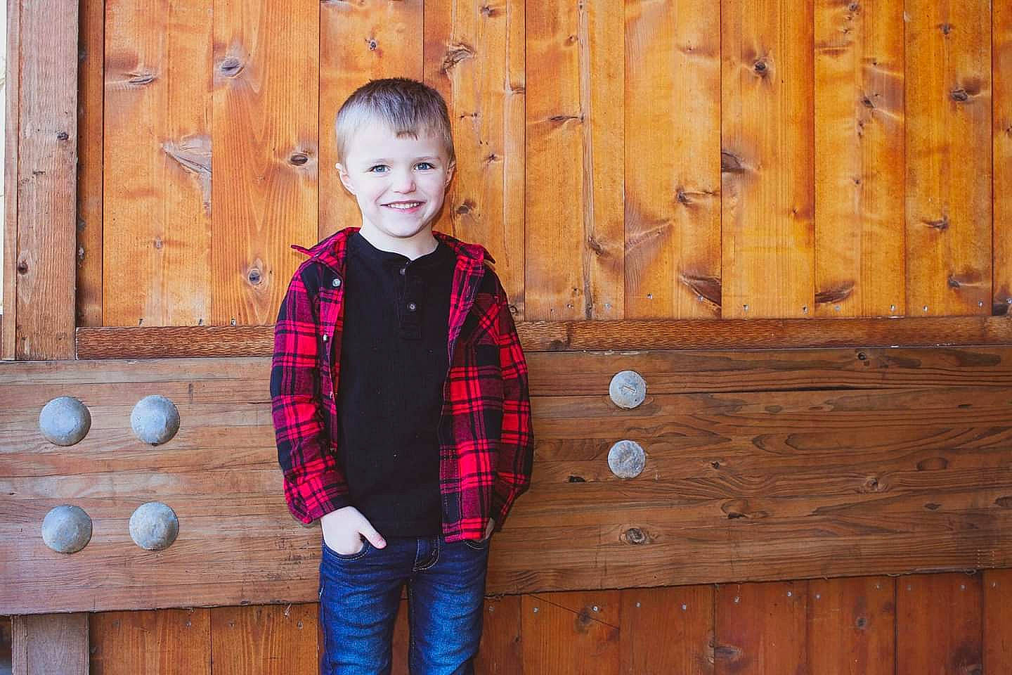 Bradyn is registered to the contest to win money with this photo: child, child_model, design, jacket, joy, outerwear, pattern, person, photography, plaid, standing, tartan, textile, toddler, winter, wood, wood_stain