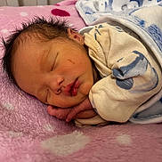 Xev Paculanan joined the competition — help win amazing prizes! newborn, baby, sleeping, blanket, pink, blue, polka_dots, cozy, infant, cute, soft, peaceful, wrapped, clothing, portrait, face, hand, resting, indoors, child