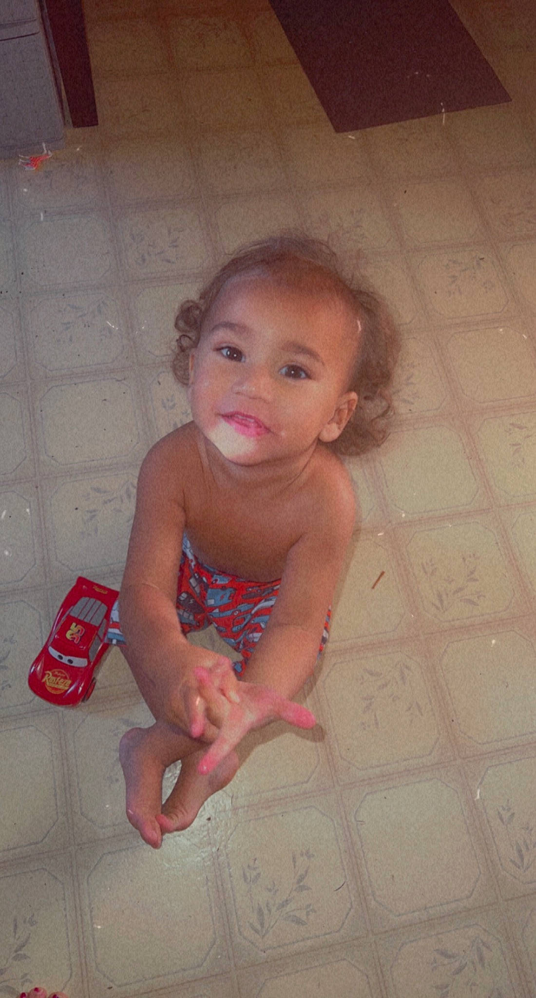 Traycen is registered to the contest to win money with this photo: baby, baby_toddler_clothing, bathing, cheek, chest, chin, floor, flooring, foot, hand, hardwood, human_leg, iris, mouth, nose, person, sitting, skin, toddler, trunk