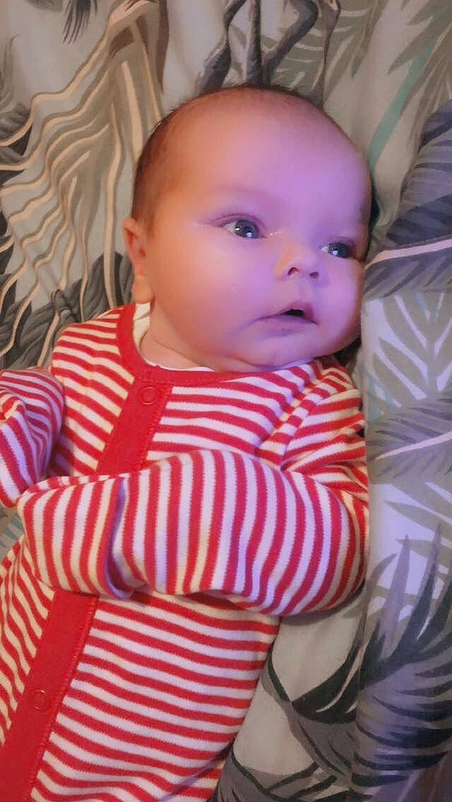 Colton is registered to the contest to win money with this photo: baby, baby_toddler_clothing, cheek, child, chin, comfort, eye, facial_expression, hairstyle, head, iris, lip, mouth, nose, person, pink, skin, sleeve, standing, textile