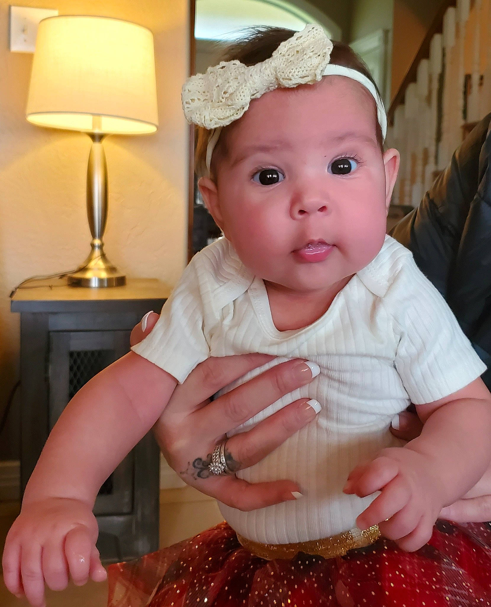 Oaklee is registered to the contest to win money with this photo: baby, baby_toddler_clothing, cheek, child, dress, eye, fashion_accessory, happy, headband, headpiece, headwear, iris, jewellery, nail, peach, person, pink, sitting, skin, sleeve
