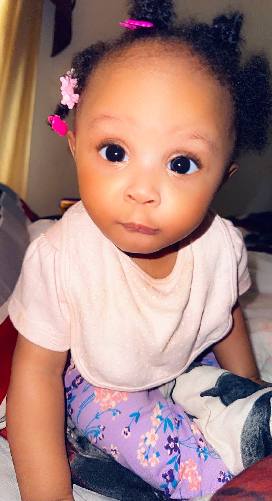 Malia is registered to the contest to win money with this photo: baby_toddler_clothing, cheek, child, chin, eyebrow, eyelash, facial_expression, flash_photography, flower, hairstyle, iris, lip, neck, nose, people, person, pink, skin, sleeve, toddler